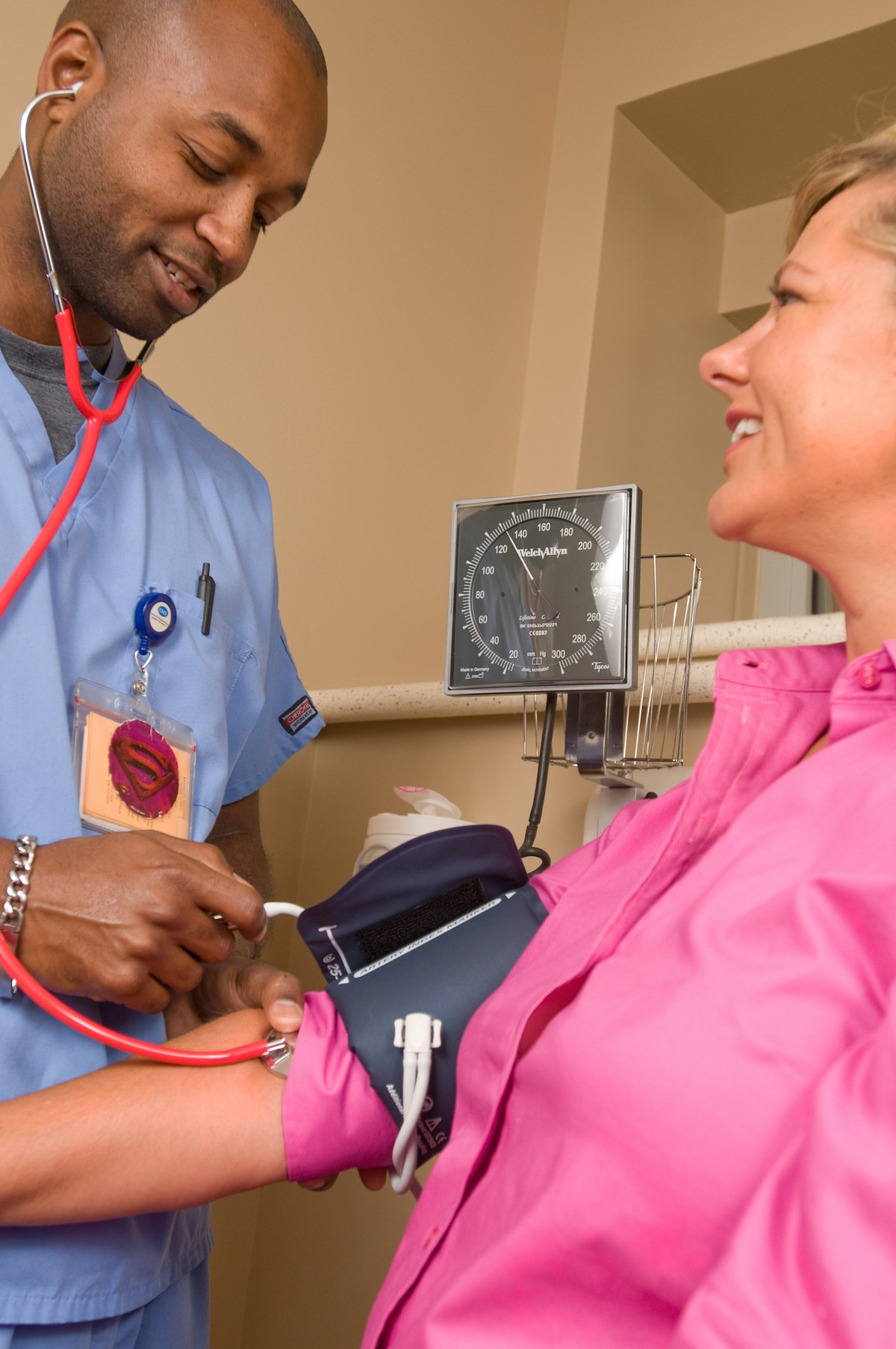 Nurse measuring patient blood pressure with cuff